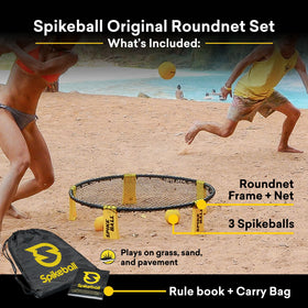 Spikeball net in sand play adds beachside competition and fun.