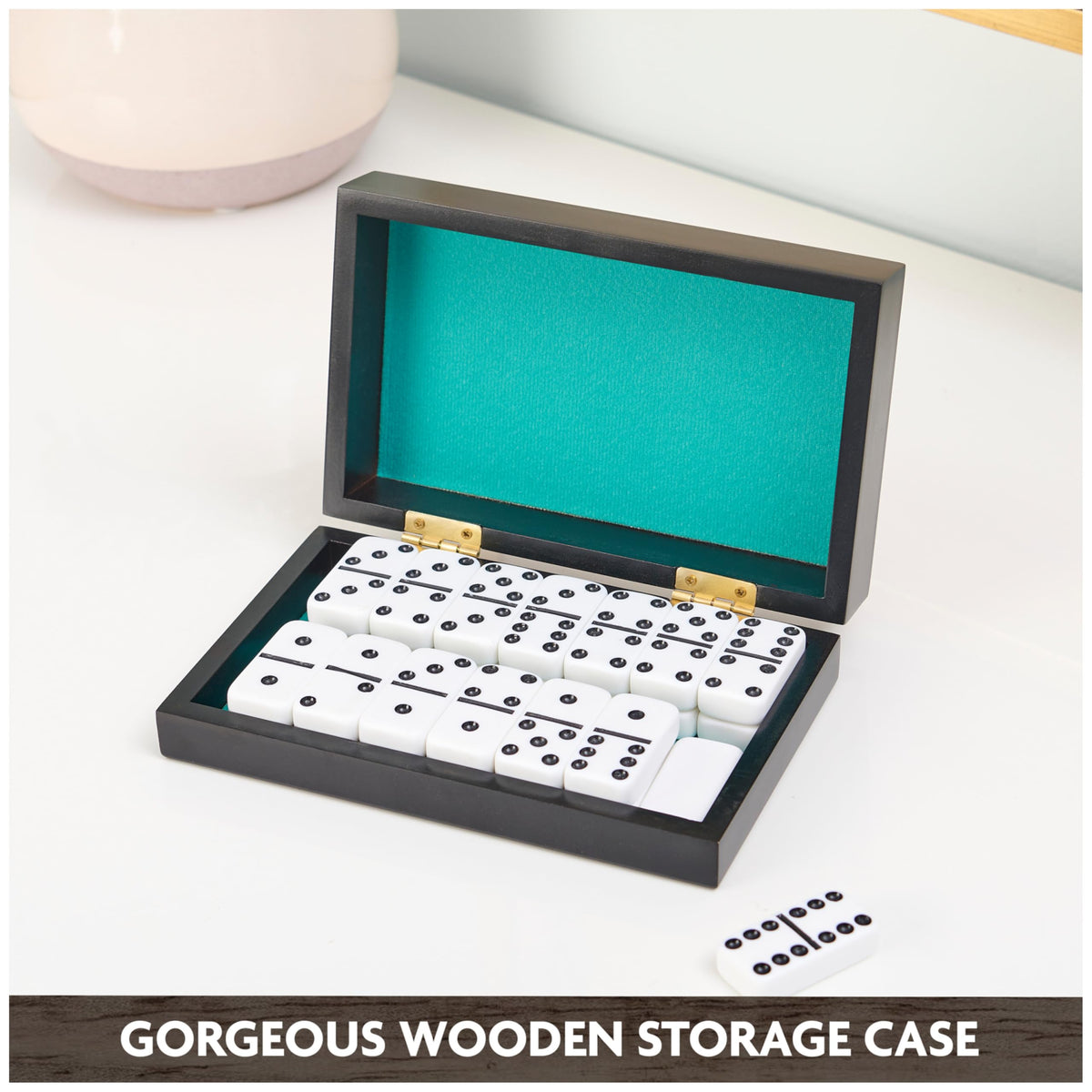 Portable wooden case with green lining protects dominoes during travel and storage.