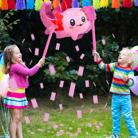Sratte pink axolotl pinata in use at celebration.