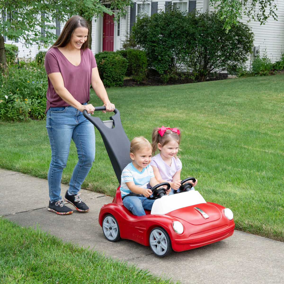 Step2 Side-by-Side Roadster parent grip demonstrates secure pushing for caregivers