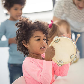 Stoie's wooden bell stick helps guide percussion sessions.