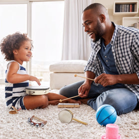 Stoie's wooden tambourine adds a steady beat for family music time.