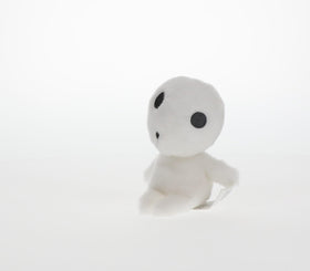 Studio Ghibli Kodama plush sits upright for desk display.