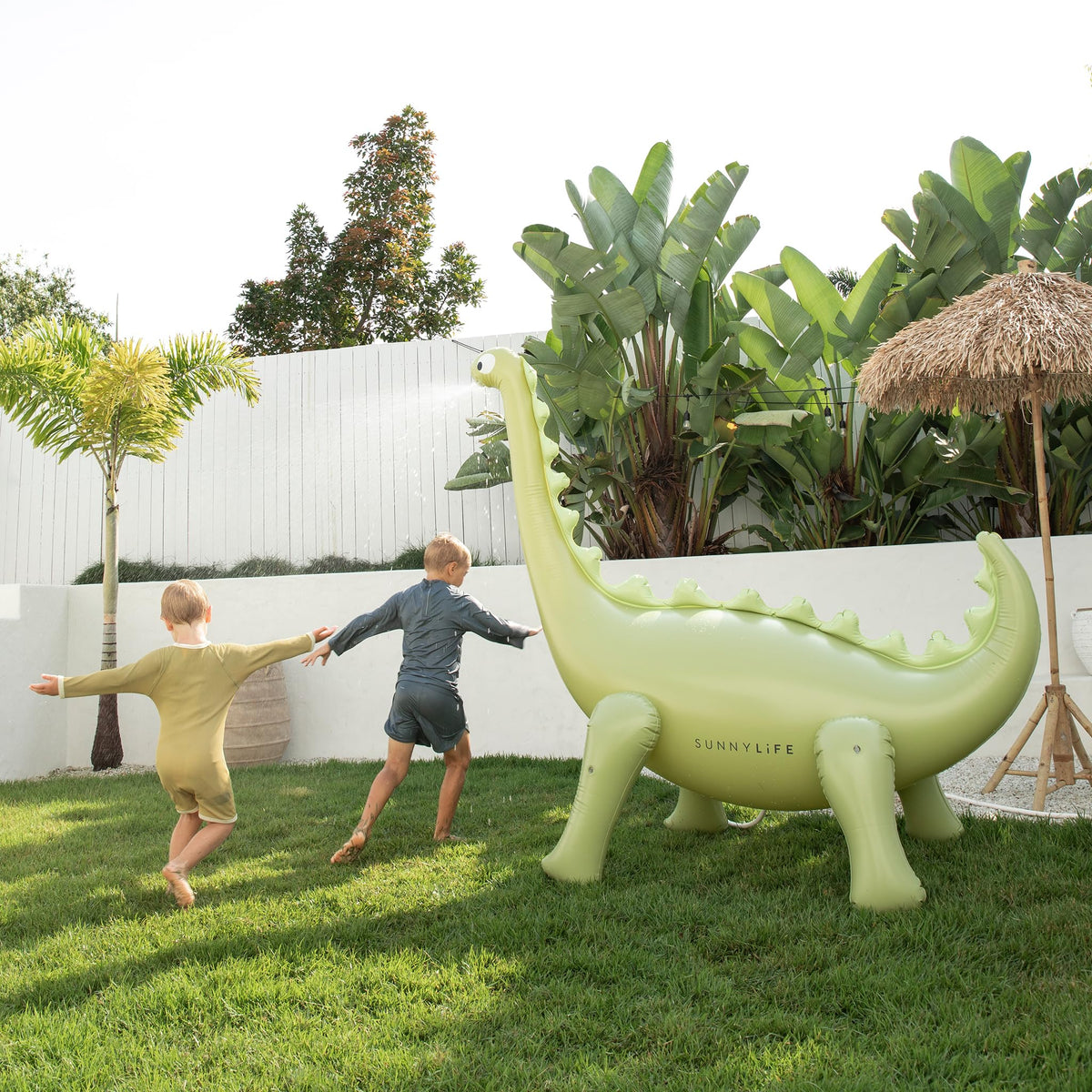 Sunnylife 6-foot-tall dinosaur sprinkler stands above the lawn as a yard centerpiece