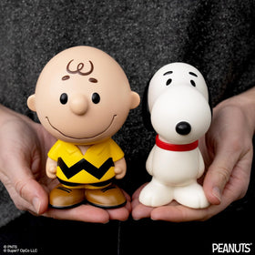 Super7 Charlie Brown yellow figure shown on a shelf with other Peanuts figures