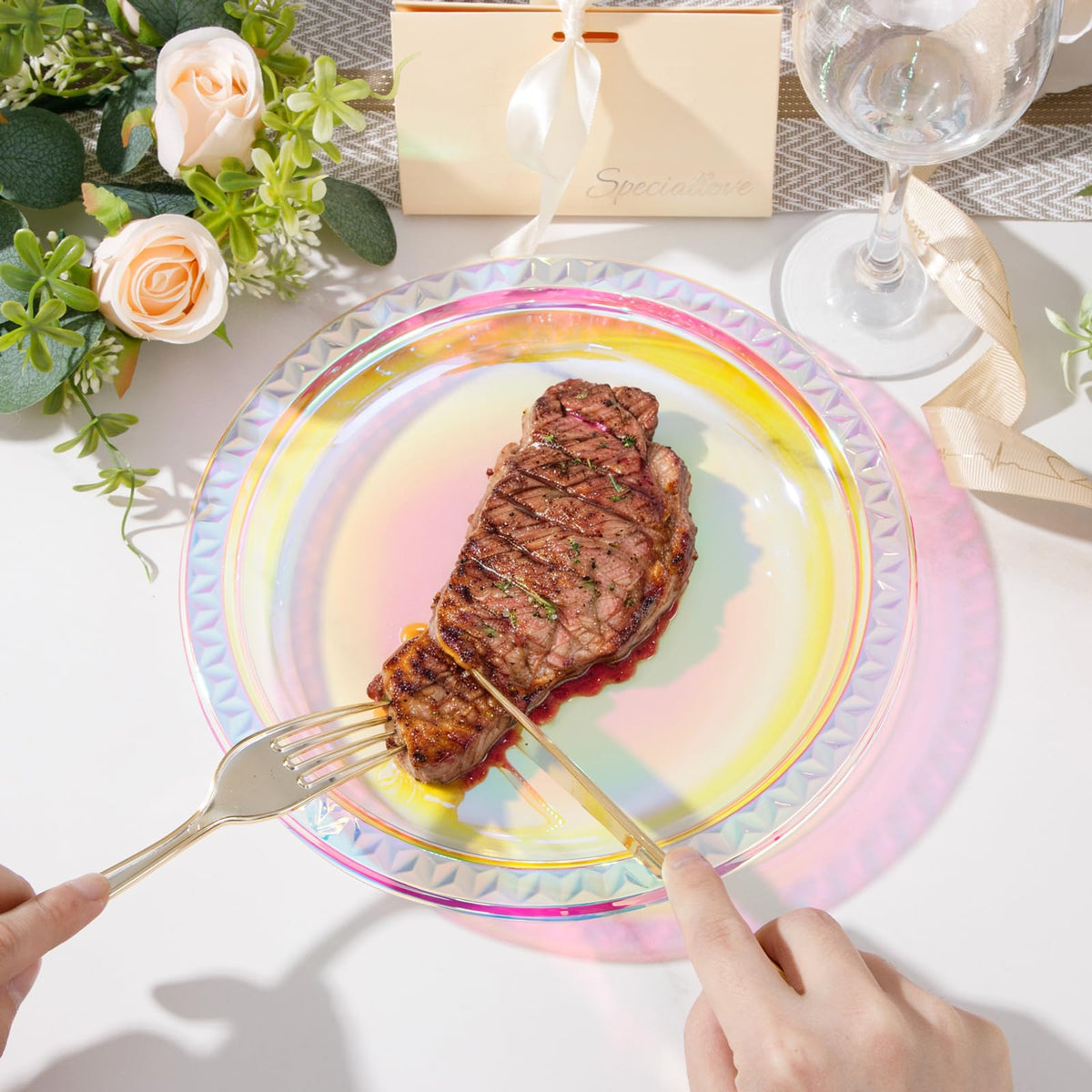 Table setting featuring Supernal iridescent plates under lights for rainbow glow.