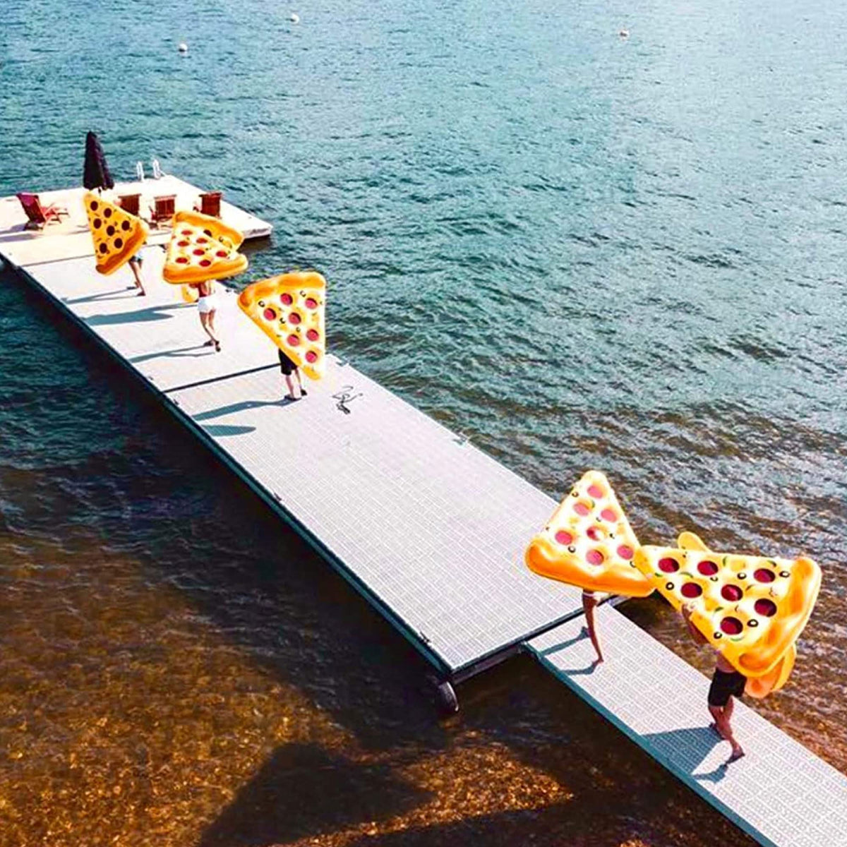 Swimline pizza slice float on water during pool play.