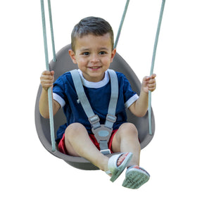 Swurfer Coconut toddler swing outdoors in gray with secure 3-point harness.