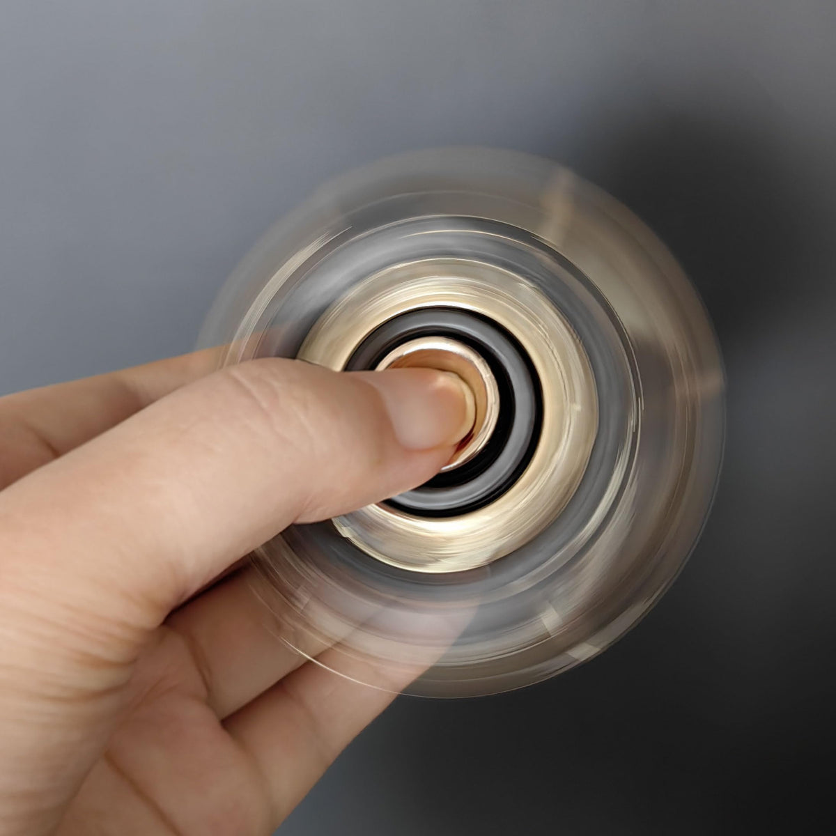 T-Conceal gray-gold fidget slider in use for focus and stress management.