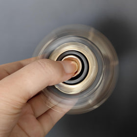 T-Conceal gray-gold fidget slider in use for focus and stress management.