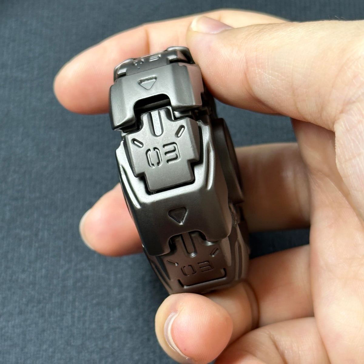 T-Conceal open armor top in hand: portable fidget for on-the-go concentration.