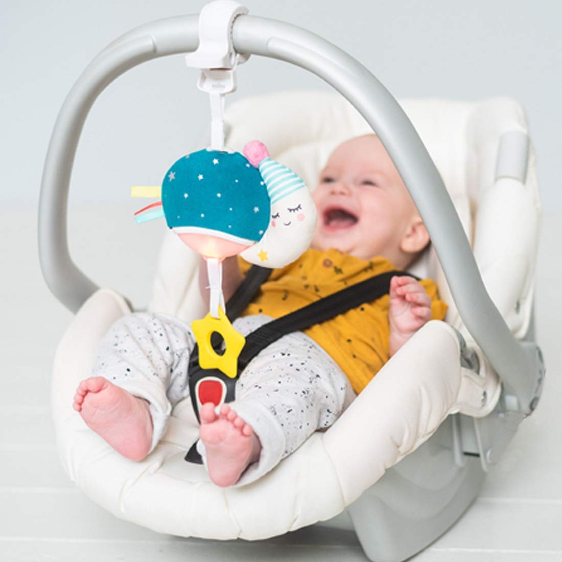 Taf Toys Musical Mini Moon melodies and lights engage baby during strolls.