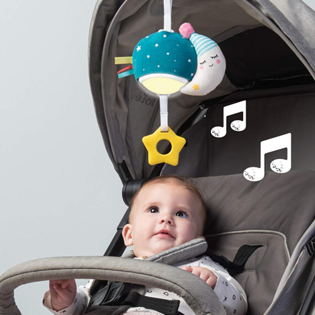 Taf Toys Musical Mini Moon on-the-go design calms baby during outings.