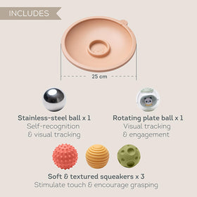 Taf Toys baby grasps a textured ball, highlighting easy grip for tiny hands.