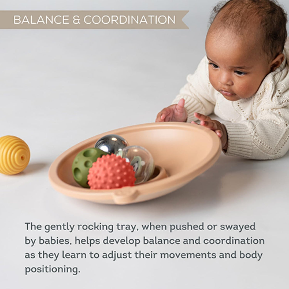 Taf Toys on-tray play illustrates active reaching and tracking during gentle sessions.