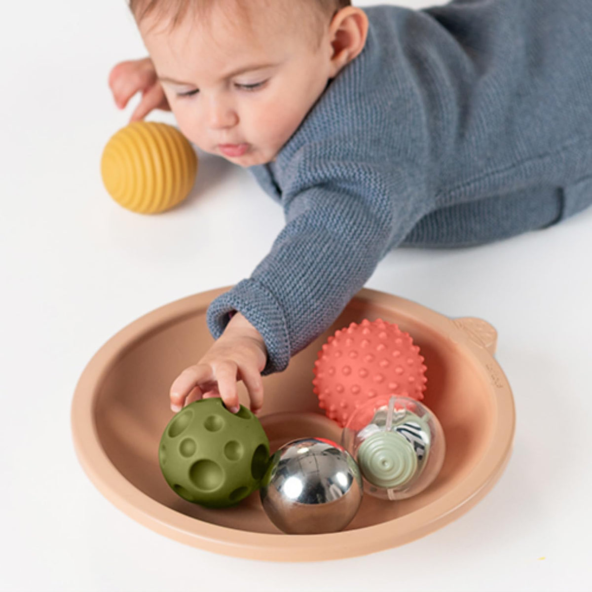 Taf Toys sensory play encourages posture and engagement during supervised tummy time.