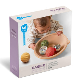 Taf Toys tummy time play tray interaction close-up showing curious baby reaching.