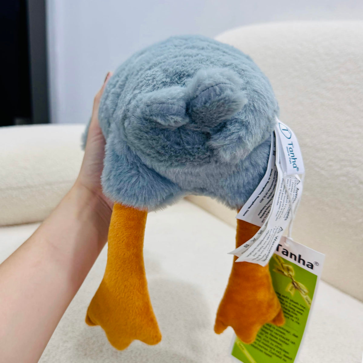 Kids playing with Tanha Goose plush cuddly buddy