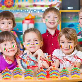 Children crafting with Tanlade shell bottle necklaces in a classroom.
