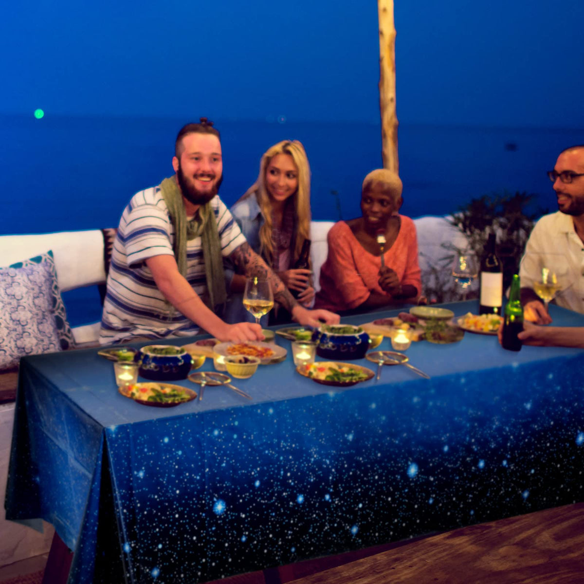 Tatuo galaxy table cover complements decor for coordinated party theme.