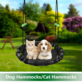 TBMLC saucer swing hung from a tree for outdoor relaxation.