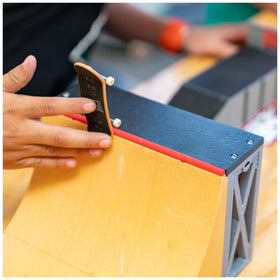 Tech Deck ramp enables speed and tricks like 50-50 grinds on a mini ramp.