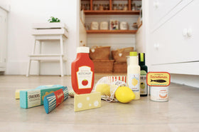 Tender Leaf basket with play items, shown during organized pretend shopping activity.