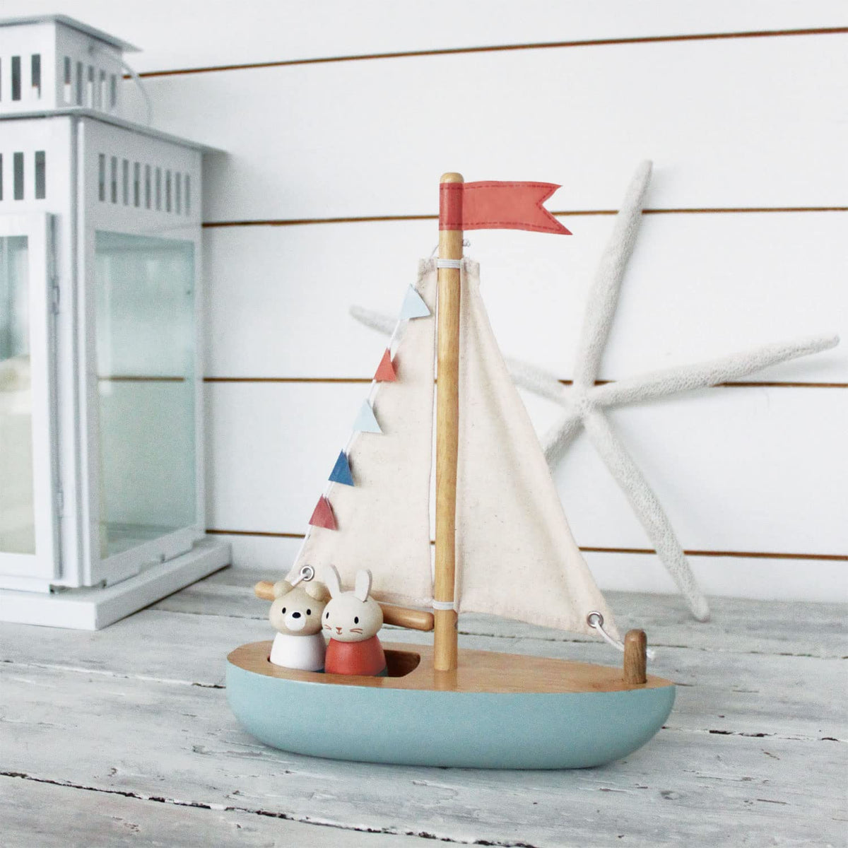 Tender Leaf Sailaway Boat on a wooden surface ready for playtime.