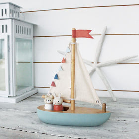Tender Leaf Sailaway Boat on a wooden surface ready for playtime.