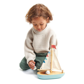 Tender Leaf Sailaway Boat close-up reveals painted wood and fabric sails.