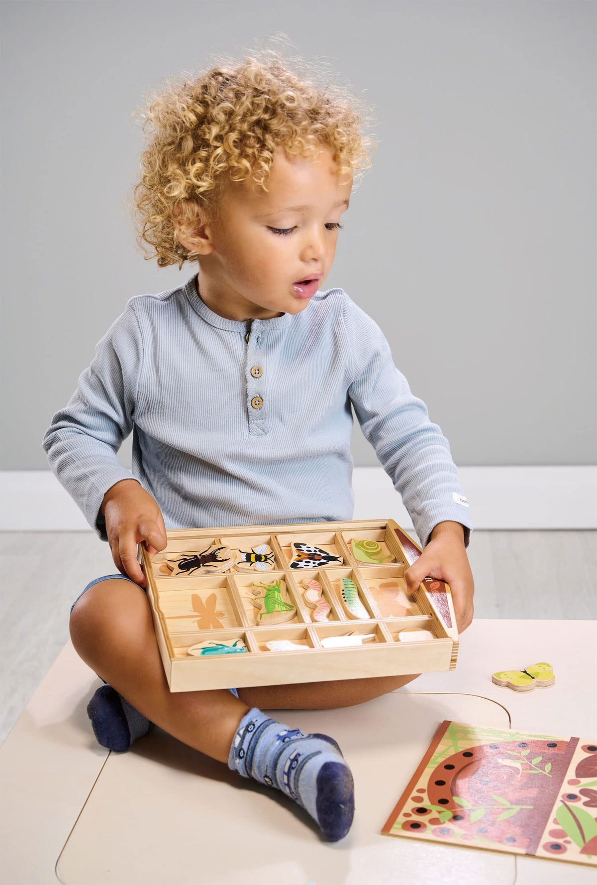 Tender Leaf Toys worm figure fosters close-up observation during playtime.