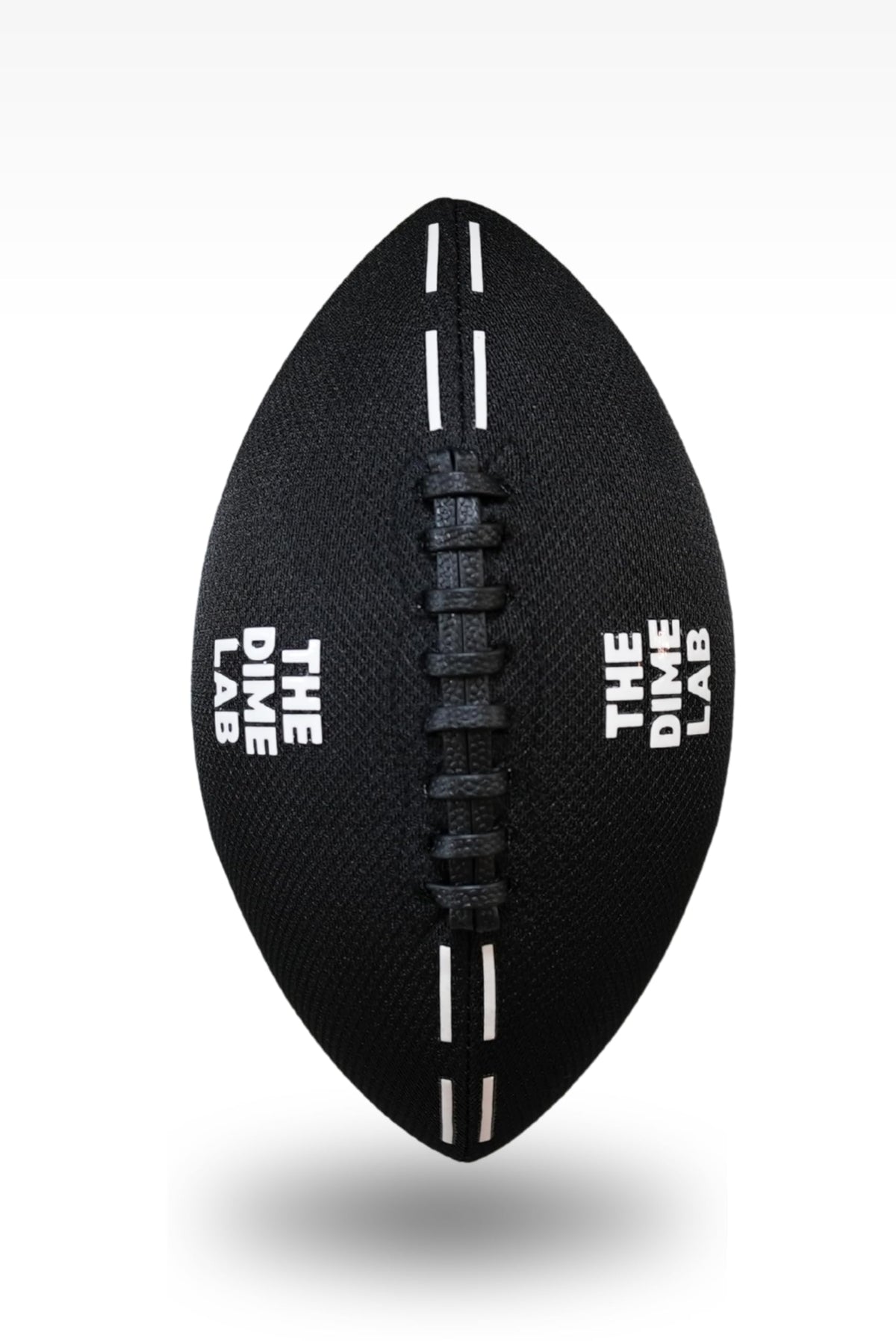 The Dime Lab water football on the beach highlighting the durable microfiber cover.