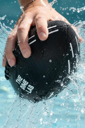 The Dime Lab water football with silicone grip strips shown wet for excellent control.