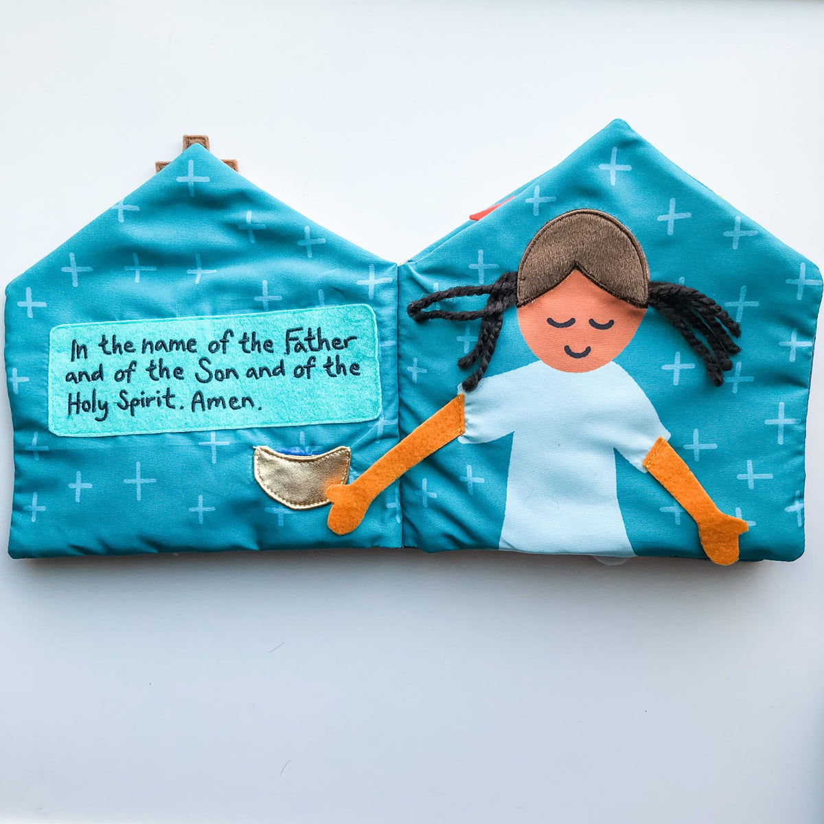 The Little Rose Shop quiet book's interactive activities keep toddlers curious during Mass.