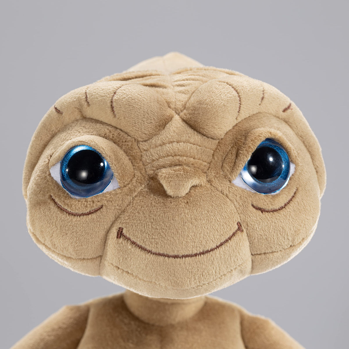 Face closeup of The Noble Collection ET Plush highlights features