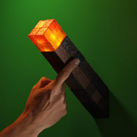The Noble Collection Minecraft Torch compact 10-inch height fits on shelves.