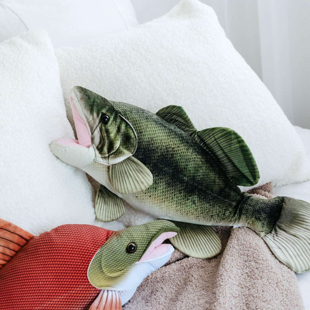 The Petting Zoo bass plush with visible fins enhances realistic river play.