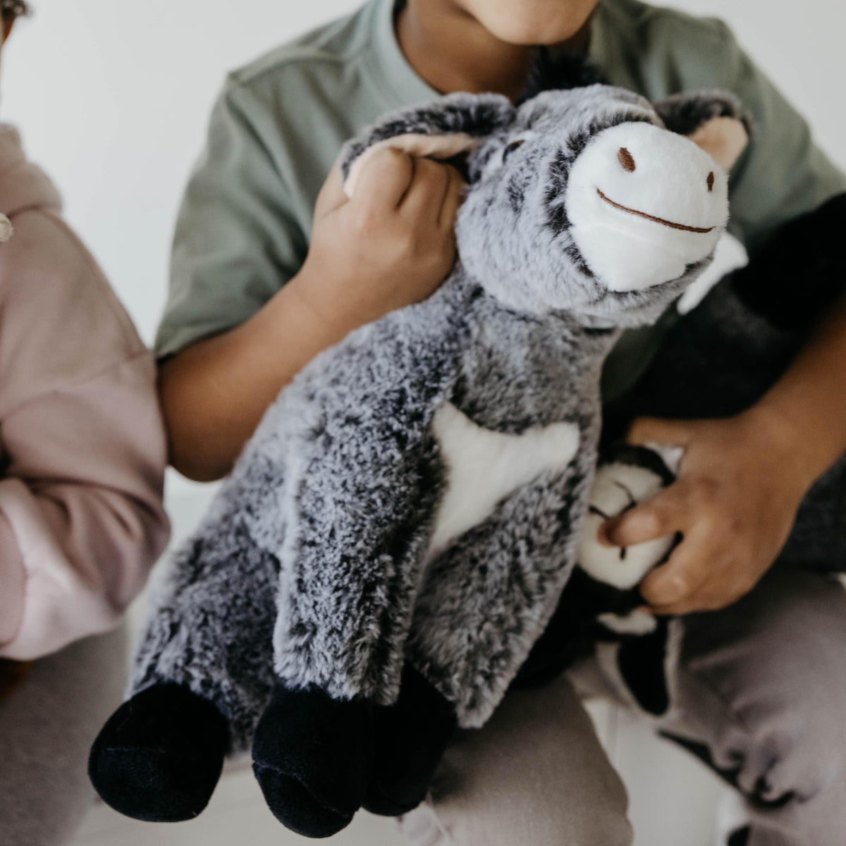 The Petting Zoo donkey plush sitting stance ready for pretend play.