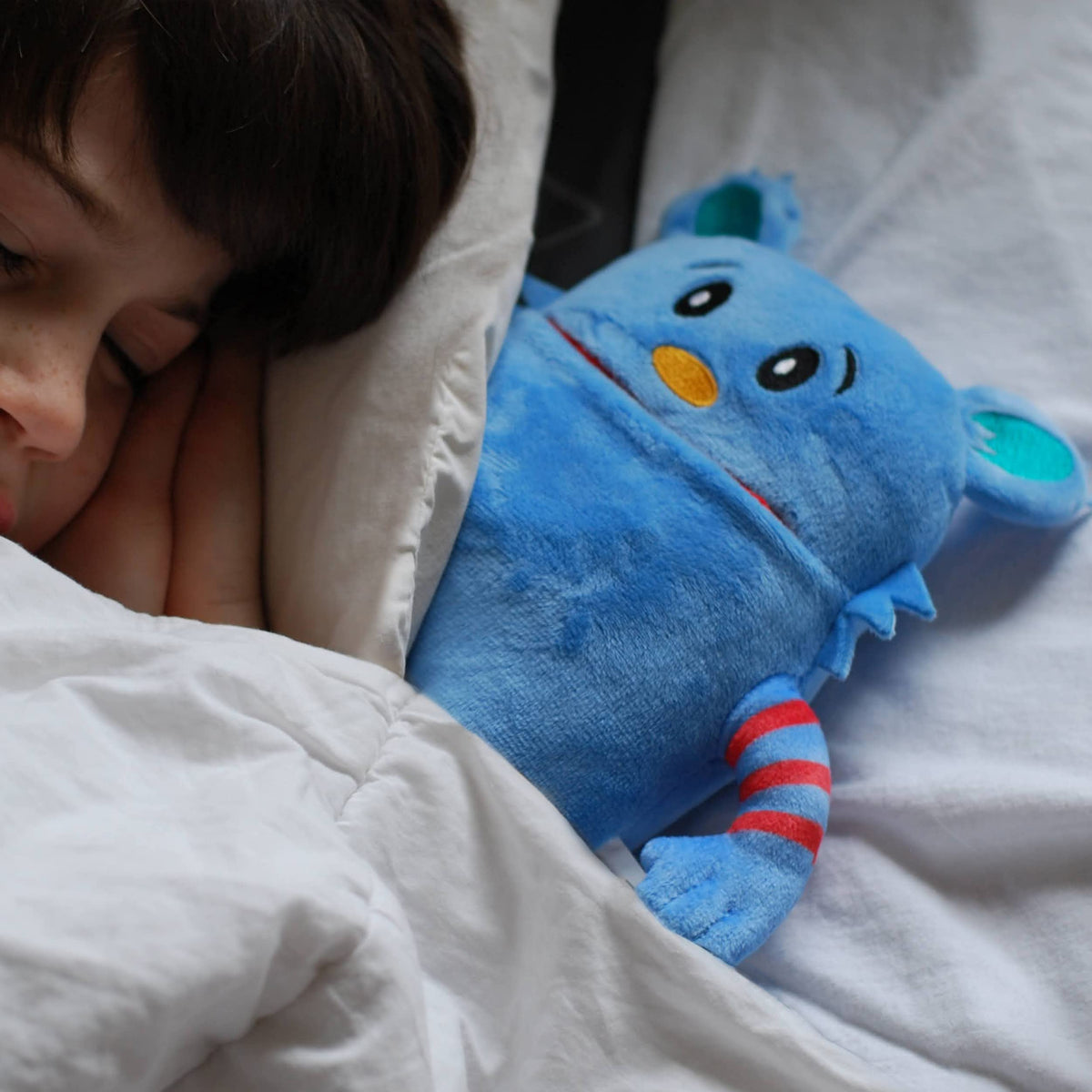 The Tooth Brigade blue monster pillow closeup highlights soft texture ideal for cuddles.
