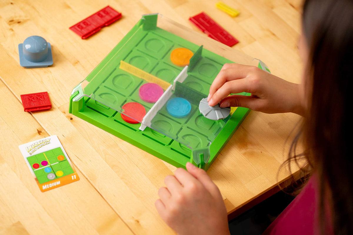 ThinkFun Invasion of the Cow Snatchers magnetic tokens image with UFO, cows and bull for problem solving.