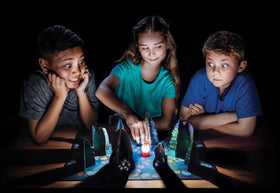 ThinkFun Shadows In The Forest mini lantern with batteries included for atmospheric play.