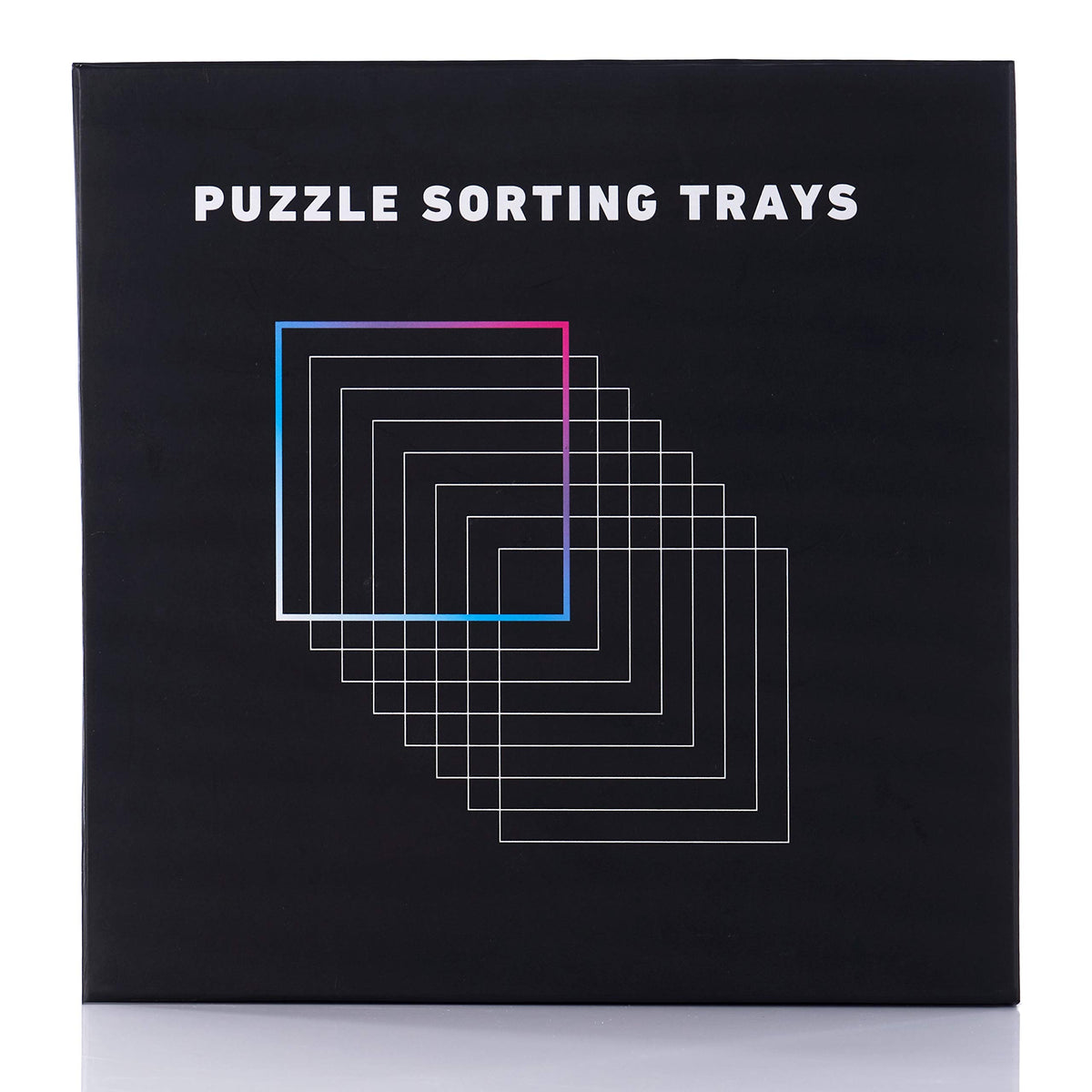 Tidyboss puzzle trays on a black surface highlighting easy piece sorting.