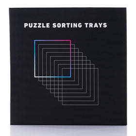 Tidyboss puzzle trays on a black surface highlighting easy piece sorting.