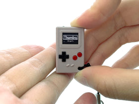 TinyCircuits Thumby front view with OLED display and controls for portable retro gaming.