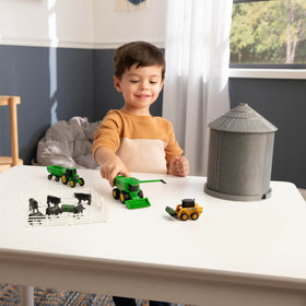 TOMY John Deere feed bales for authentic farm chores.