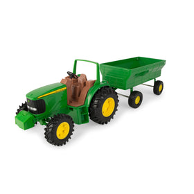 TOMY John Deere tractor with steerable front axle for realistic steering during play.