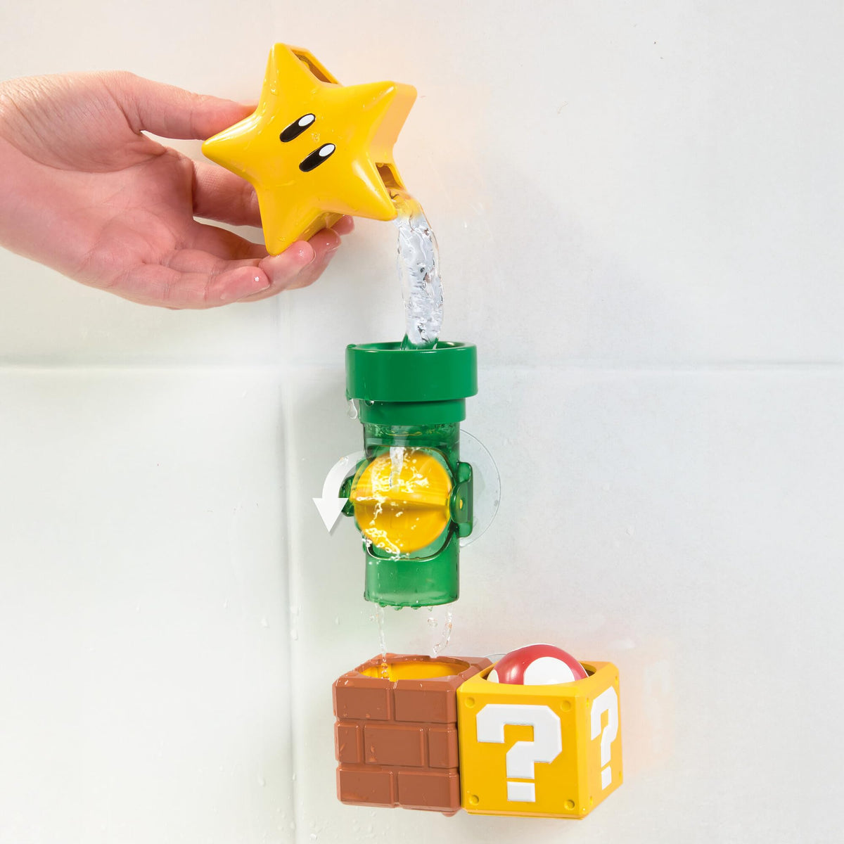 TOMY My Mario Pipes Playset pours water to spin coins during bath time.