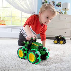 TOMY Monster Treads Lightning Wheels John Deere Tractor frustration-free packaging for quick setup.