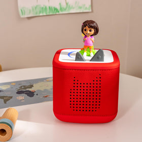 Tonies Dora two-language learning visualizes bilingual exploration through English and Spanish songs.