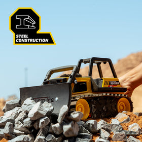 Tonka bulldozer demonstrates dirt and sand movement on pretend job sites.